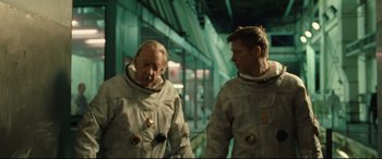 Movie still from “Ad Astra” (2019), directed by James Gray – Two men in spacesuits are standing next to each other; Medium shot, Over the shoulder angle