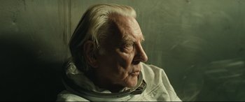 Movie still from “Ad Astra” (2019), directed by James Gray – An older man wearing a neck brace looking off into the distance; Close Up shot, Low angle