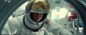 Movie still from “Ad Astra” (2019), directed by James Gray – A man in a spacesuit and a helmet; Medium shot, Overhead angle