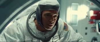 Movie still from “Ad Astra” (2019), directed by James Gray – A person wearing a spacesuit; Close Up shot, Overhead angle