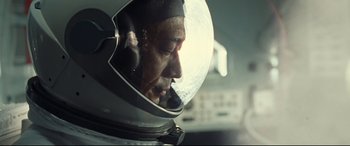 Movie still from “Ad Astra” (2019), directed by James Gray – A man wearing a helmet with a headset on; Close Up shot, Low angle