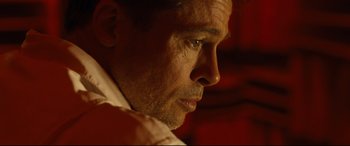 Movie still from “Ad Astra” (2019), directed by James Gray – A man's face in a red room; Close Up shot, Low angle