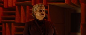 Movie still from “Ad Astra” (2019), directed by James Gray – An older woman wearing a suit and a black shirt; Medium shot, Low angle