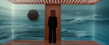 Movie still from “Ad Astra” (2019), directed by James Gray – A woman standing in front of an ocean view; Wide shot, Low angle