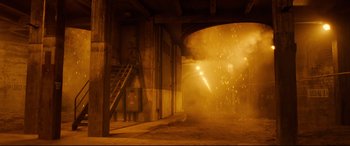 Movie still from “Ad Astra” (2019), directed by James Gray – A fire is burning in a building near a fire hydrant; Extreme Wide shot, Low angle