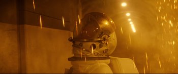Movie still from “Ad Astra” (2019), directed by James Gray – An astronaut's helmet is lit up in the dark; Medium shot, Low angle