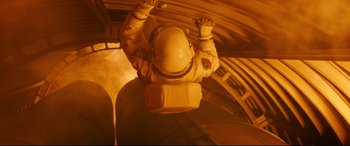 Movie still from “Ad Astra” (2019), directed by James Gray – A person in a spacesuit hanging from the side of an airplane; Medium shot, Overhead angle