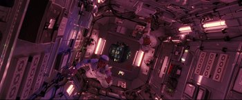 Movie still from “Ad Astra” (2019), directed by James Gray – An overhead view of an astronaut in a space station; Wide shot, Overhead angle