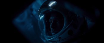 Movie still from “Ad Astra” (2019), directed by James Gray – A man in a space helmet looking into the distance; Close Up shot, Overhead angle