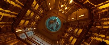 Movie still from “Ad Astra” (2019), directed by James Gray – A person in a space suit inside a space station; Wide shot, Overhead angle