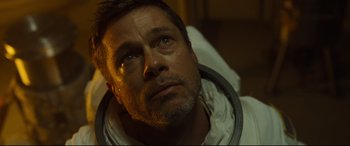 Movie still from “Ad Astra” (2019), directed by James Gray – A person wearing a white shirt; Close Up shot, Low angle