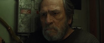 Movie still from “Ad Astra” (2019), directed by James Gray – An old man with a beard is looking at the camera; Close Up shot, Low angle
