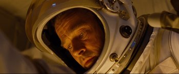 Movie still from “Ad Astra” (2019), directed by James Gray – A person wearing a space suit; Close Up shot, Low angle