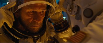 Movie still from “Ad Astra” (2019), directed by James Gray – A person wearing a space suit; Close Up shot, Low angle
