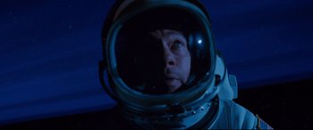 Movie still from “Ad Astra” (2019), directed by James Gray – A man in a space suit looking into a mirror; Close Up shot, Overhead angle