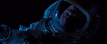 Movie still from “Ad Astra” (2019), directed by James Gray – A man in a space suit looking up at the sky; Close Up shot, Overhead angle