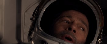 Movie still from “Ad Astra” (2019), directed by James Gray – A person wearing a space helmet; Close Up shot, Overhead angle