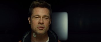 Movie still from “Ad Astra” (2019), directed by James Gray – A person wearing a jacket; Close Up shot, Over the shoulder angle