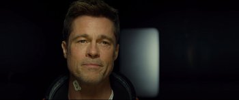 Movie still from “Ad Astra” (2019), directed by James Gray – A person wearing a jacket; Close Up shot, Over the shoulder angle