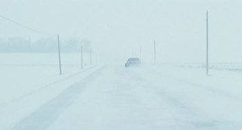 Movie still from “Fargo” (1996), directed by Ethan Coen – A car driving down a road in the middle of a snow storm; Extreme Wide shot, High angle