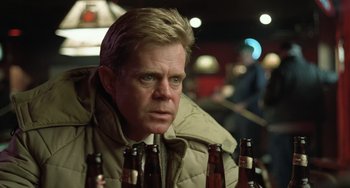 Movie still from “Fargo” (1996), directed by Ethan Coen – A person sitting in front of a group of beer bottles; Close Up shot, Over the shoulder angle