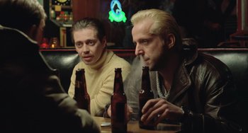 Movie still from “Fargo” (1996), directed by Ethan Coen – A couple of men sitting at a table with beer bottles; Medium shot, Over the shoulder angle