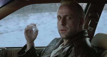 Movie still from “Fargo” (1996), directed by Ethan Coen – A man sitting in the back of a car holding a piece of paper; Close Up shot, Low angle
