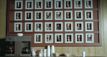 Movie still from “Fargo” (1996), directed by Ethan Coen – A bunch of pictures on the wall in a restaurant; Medium shot, High angle
