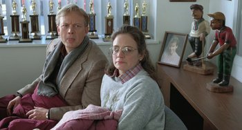 Movie still from “Fargo” (1996), directed by Ethan Coen – A man and a woman sitting next to each other in a room; Medium shot, High angle