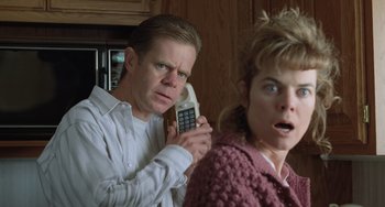 Movie still from “Fargo” (1996), directed by Ethan Coen – A man and a woman are holding a cell phone; Close Up shot, Low angle