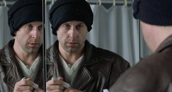 Movie still from “Fargo” (1996), directed by Ethan Coen – A man in a leather jacket looking at his reflection in a mirror; Close Up shot, Over the shoulder angle