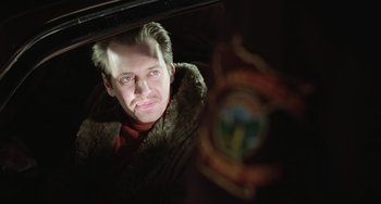 Movie still from “Fargo” (1996), directed by Ethan Coen – A man in a fur coat looking into a mirror; Close Up shot, Low angle