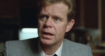 Movie still from “Fargo” (1996), directed by Ethan Coen – A person wearing a suit and tie; Close Up shot, Low angle