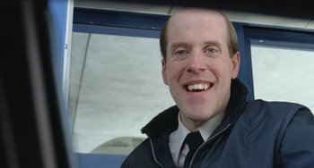 Movie still from “Fargo” (1996), directed by Ethan Coen – A man smiling for the camera while wearing a jacket; Close Up shot, Low angle