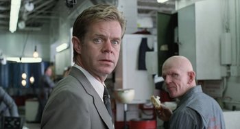 Movie still from “Fargo” (1996), directed by Ethan Coen – A man in a suit and tie standing next to another man in a suit and tie; Close Up shot, Low angle