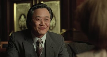 Movie still from “Fargo” (1996), directed by Ethan Coen – A man in a suit and tie sitting in a room; Close Up shot, Over the shoulder angle