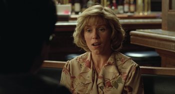 Movie still from “Fargo” (1996), directed by Ethan Coen – A woman sitting at a table in front of a glass of wine; Close Up shot, Over the shoulder angle