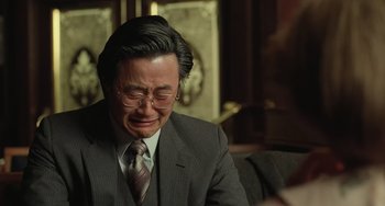 Movie still from “Fargo” (1996), directed by Ethan Coen – A man in a suit and tie sitting in front of a mirror; Close Up shot, Over the shoulder angle