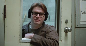 Movie still from “Fargo” (1996), directed by Ethan Coen – A man wearing ear muffs looking out of a window; Close Up shot, Over the shoulder angle