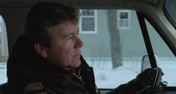 Movie still from “Fargo” (1996), directed by Ethan Coen – A man sitting in the driver's seat of a car; Close Up shot, Low angle