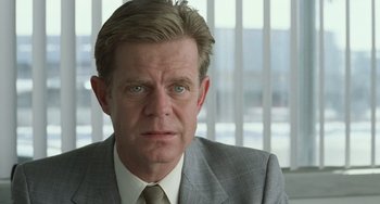 Movie still from “Fargo” (1996), directed by Ethan Coen – A person wearing a suit and tie; Close Up shot, Over the shoulder angle