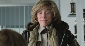 Movie still from “Fargo” (1996), directed by Ethan Coen – A woman with blonde hair wearing a brown jacket; Close Up shot, Low angle