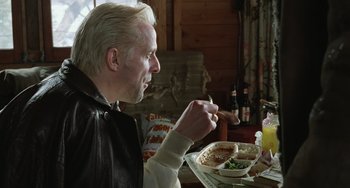 Movie still from “Fargo” (1996), directed by Ethan Coen – A man sitting at a table with a plate of food in front of him; Close Up shot, Low angle