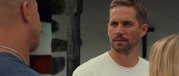 Movie still from “Fast & Furious 6” (2013), directed by Justin Lin – A person wearing a white shirt; Close Up shot, Over the shoulder angle