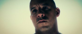 Movie still from “Fast & Furious 6” (2013), directed by Justin Lin – A man's face in a white room; Close Up shot, Low angle