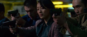Movie still from “Fast & Furious 6” (2013), directed by Justin Lin – A woman holding a gun while a man looks on; Close Up shot, Over the shoulder angle