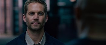 Movie still from “Fast & Furious 6” (2013), directed by Justin Lin – A person wearing a jacket; Close Up shot, Over the shoulder angle