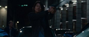 Movie still from “Fast & Furious 6” (2013), directed by Justin Lin – A man is holding a gun in a dark place; Medium shot, Low angle