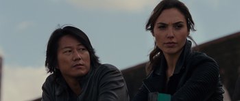 Movie still from “Fast & Furious 6” (2013), directed by Justin Lin – A man and a woman sitting next to each other; Close Up shot, Over the shoulder angle