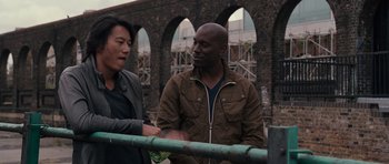 Movie still from “Fast & Furious 6” (2013), directed by Justin Lin – A man and a woman standing next to a railing; Medium shot, Over the shoulder angle